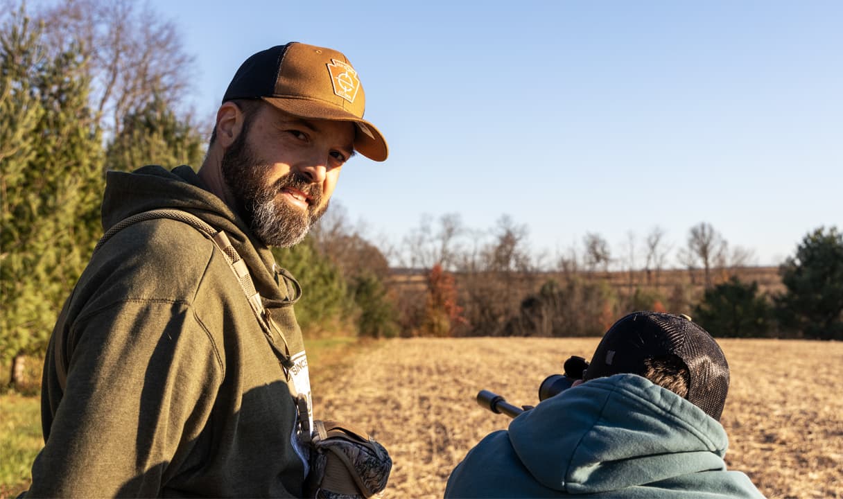 A picture of Jason smiling in a field.